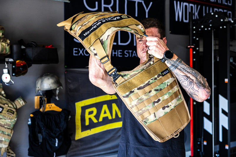 Dan Fahey of Gritty Soldier putting on the Battle Bunker Hybrid Weight Vest MK2