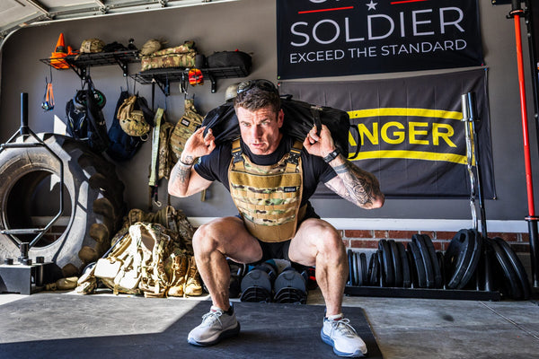 Dan Fahey of Gritty Soldier doing a sandbag squat with the Battle Bunker Raider