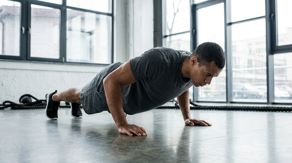 Athlete performing push-ups on a gym floor during fitness testing