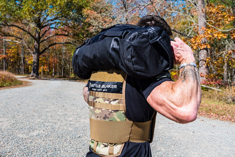 Dan Fahey of Gritty Soldier carrying a load on a trail