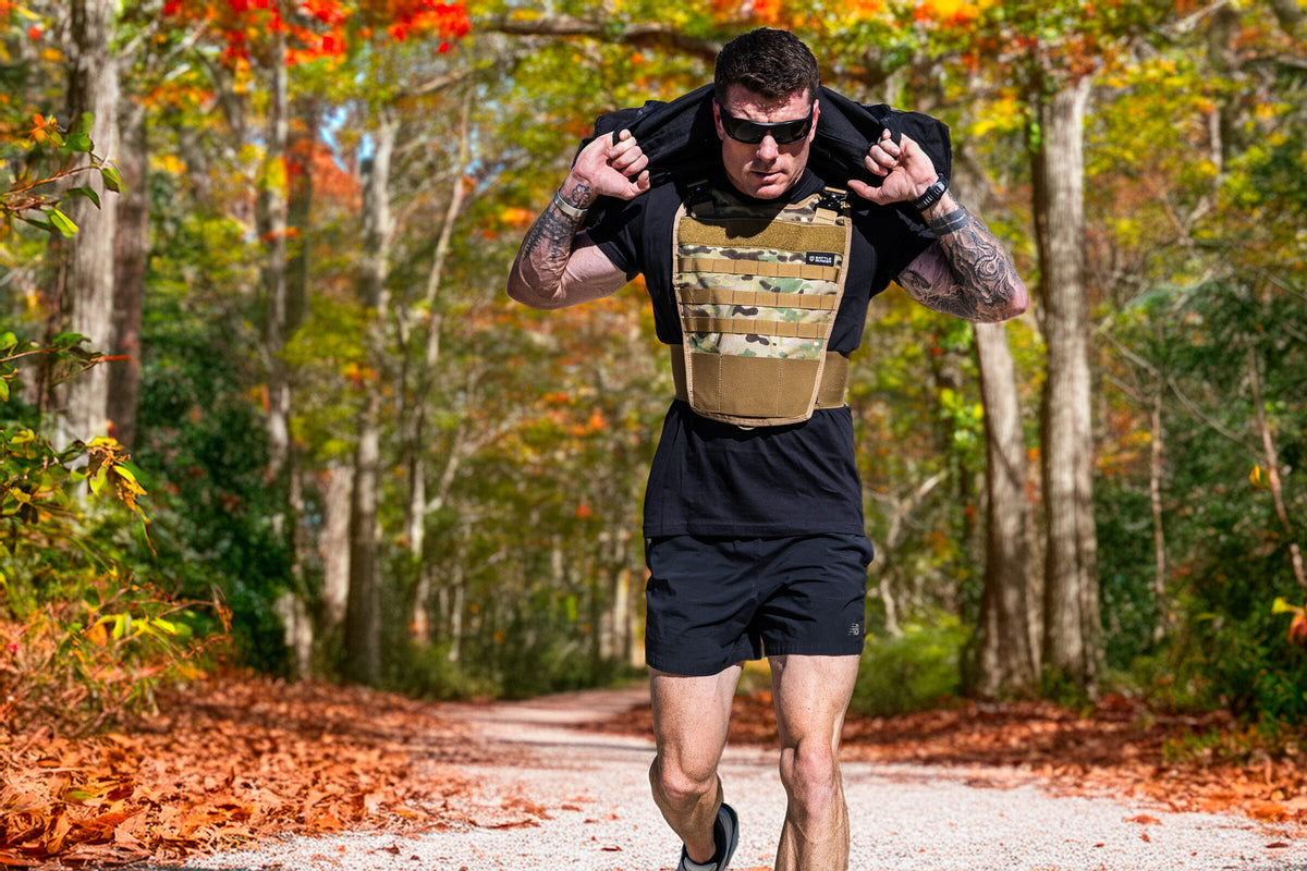 Dan Fahey of Gritty Soldier carrying a sandbag on a trail