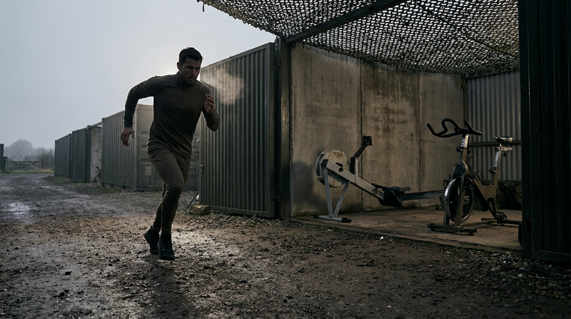 Athlete running at dawn with rower and bike nearby, comparing Navy PRT cardio options