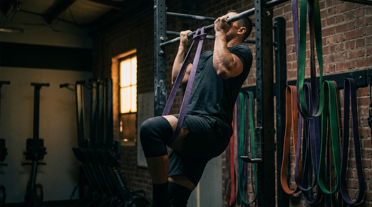Athlete doing a band-assisted pull-up with resistance bands
