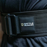 Close-up of black tactical battle bunker belt with sturdy buckle and textured strap