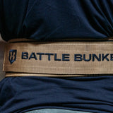 Close-up of a tan Battle Bunker lifting belt worn over a dark shirt