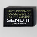Black Battle Bunker patch with bold text 'IN MY DEFENSE I WAS BORN TO F*CKIN' SEND IT' in military green and white