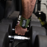 Close-up of hand wearing green Battle Wraps wrist support by Battle Bunker gripping gym dumbbell