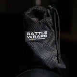 Black mesh drawstring pouch labeled Battle Wraps by Battle Bunker on dark background