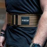 Close-up of a brown Battle Bunker tactical nylon belt worn over black shirt