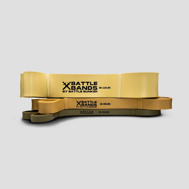 Stack of three yellow and green Battle Bands resistance bands by Battle Bunker with different weight levels