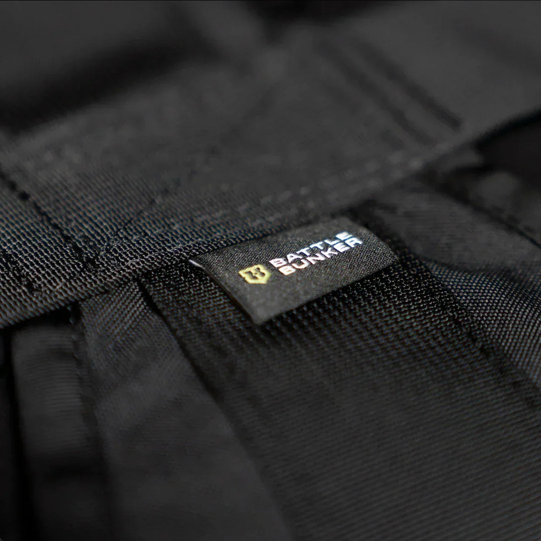Close-up of black tactical gear with a Battle Bunker branded label on durable fabric