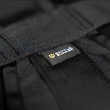 Close-up of black tactical gear with a Battle Bunker branded label on durable fabric