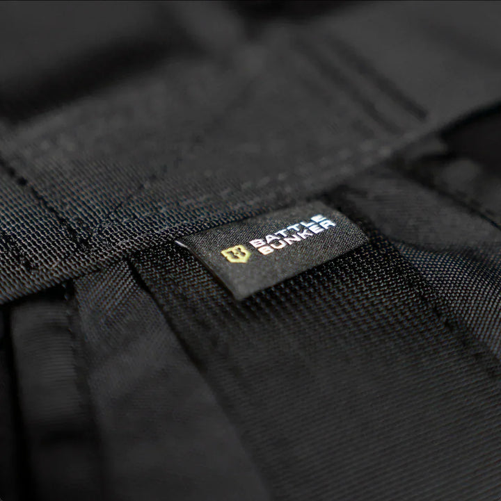 Close-up of black tactical gear with a Battle Bunker branded label on durable fabric