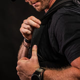 Close-up of man adjusting breathable inner padding of black Battle Bunker tactical vest