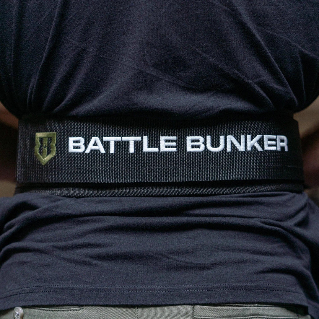 Back view of person wearing a black Battle Bunker branded weightlifting belt