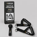 Battle Handles kit contents: two resistance band handles with textured rubber grips, nylon straps and steel carabiners, plus a door anchor, in front of the Battle Bunker box