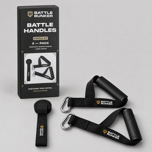 Battle Handles kit contents: two resistance band handles with textured rubber grips, nylon straps and steel carabiners, plus a door anchor, in front of the Battle Bunker box