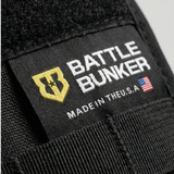 Close-up of a 'Battle Bunker' label on a black fabric background