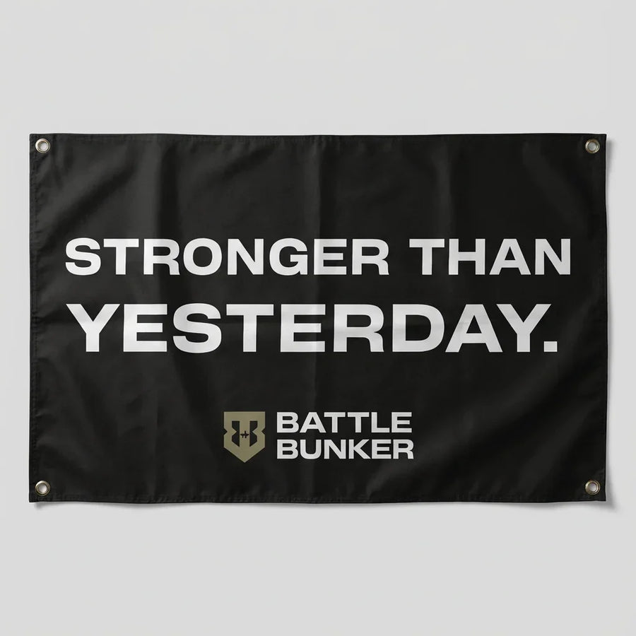 Black flag with white text Stronger Than Yesterday and Battle Bunker logo