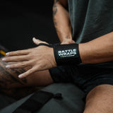Person wearing black Battle Wraps wrist support by Battle Bunker in gym setting